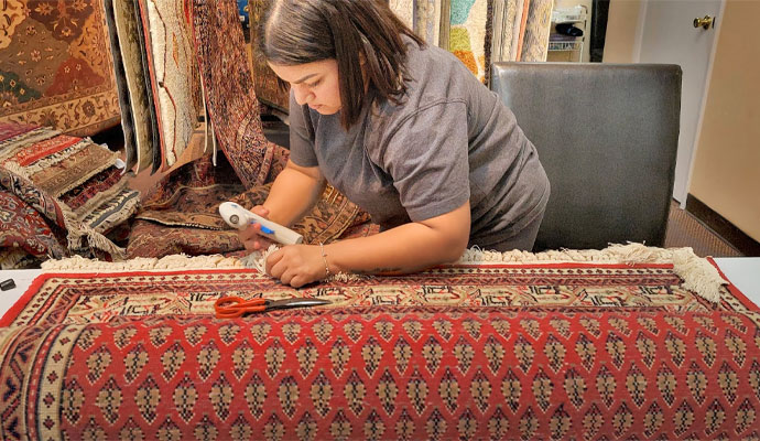 woman repairing a rug