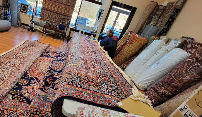 Worker removing dirt from rug