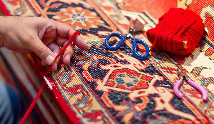 Close-up of a person professionally serging the edge